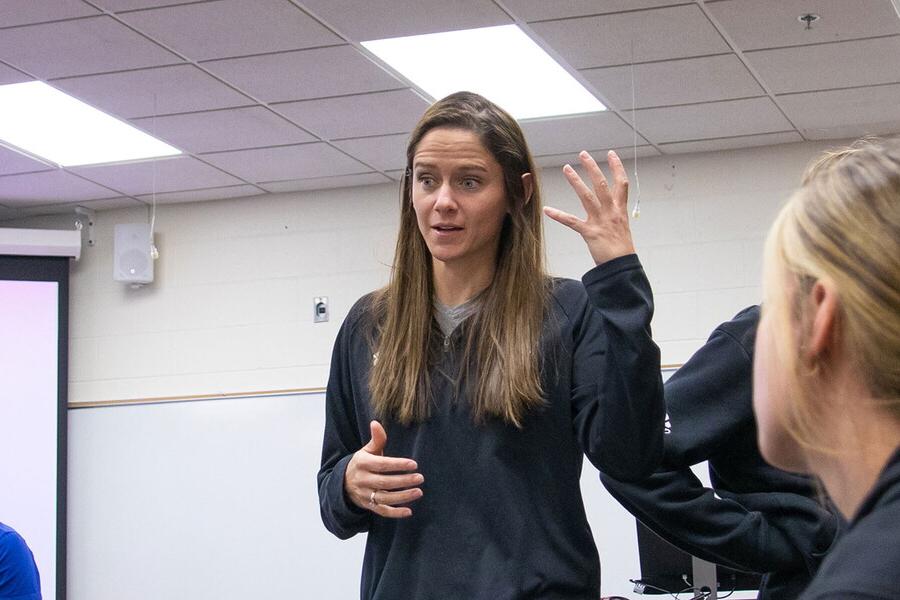 Professor Sam Wilson teaches in front of students in a classroom.